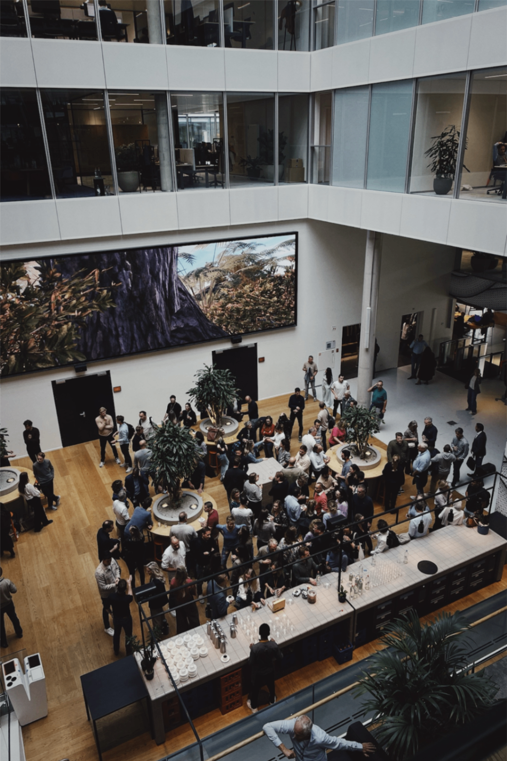 A large atrium gathering showing the scale and energy of the wider community event